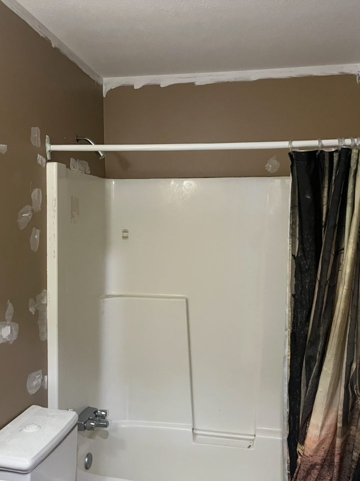 Bathroom walls filled and sanded, filler patches visible, ready for paint