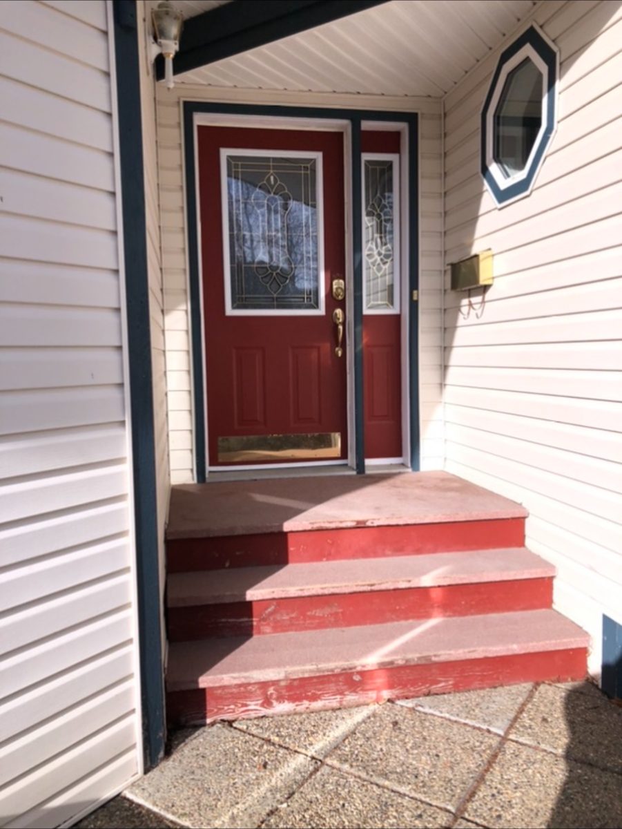 Front entry before painting, dark red door and worn red concrete steps