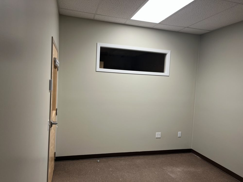 The same office finished in a soft grey-green